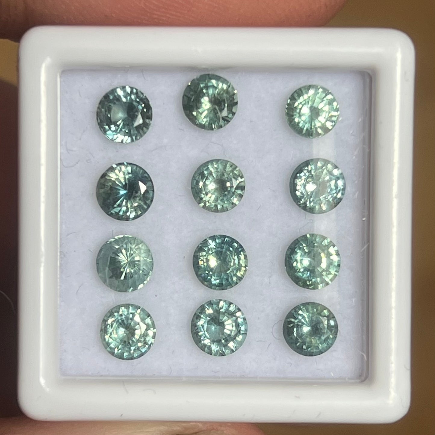 4.48ct 4.3mm Green Teal Sapphire set